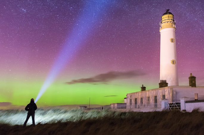 The Northern Lights at a lighthouse on Orkney